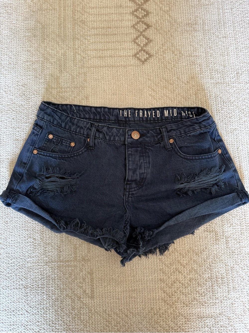 The Frayed Mid Rise Black Denim Cutoff Shorts